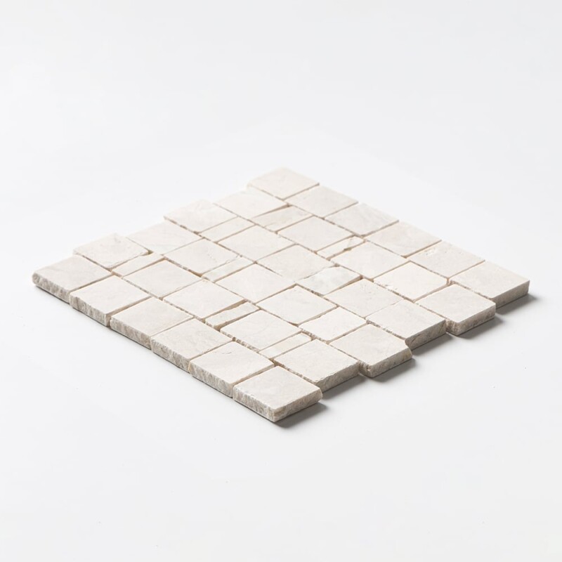 Angled perspective of Diana Royal Leather Scarpa Rough Cut Marble Mosaic tile, capturing the irregular hand-clipped edges and staggered joint pattern that give the surface its dimensional, rough-cut texture.