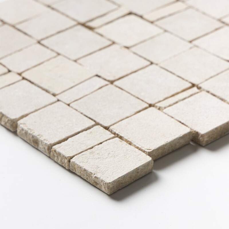 Angled perspective of Seashell Leather Scarpa Rough Cut Marble Mosaic tile, capturing the irregular hand-clipped edges and staggered joint pattern that give the surface its dimensional, rough-cut texture.
