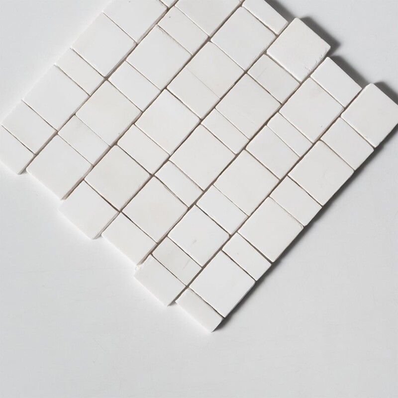 Close-up view of Bianco Dolomiti Honed Scarpa Rough Cut Marble Mosaic, highlighting the matte honed finish and delicate grey veining running across the bright white marble surface.