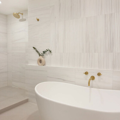 Bianco Dolomiti honed marble bathroom wall in spa style interior design by Country Floors