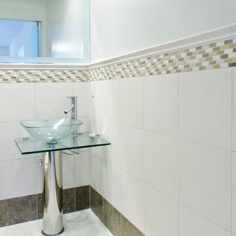 Elegant bathroom with honed limestone walls and refined neutral interior styling by Country Floors