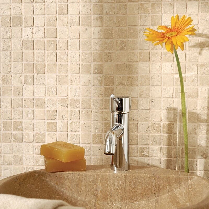 Bathroom wall with ivory tumbled mosaic tiles and warm natural ambiance by Country Floors