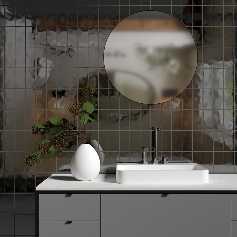 modern bathroom with bronze tone subway tiles and round mirror accent lighting by Country Floors