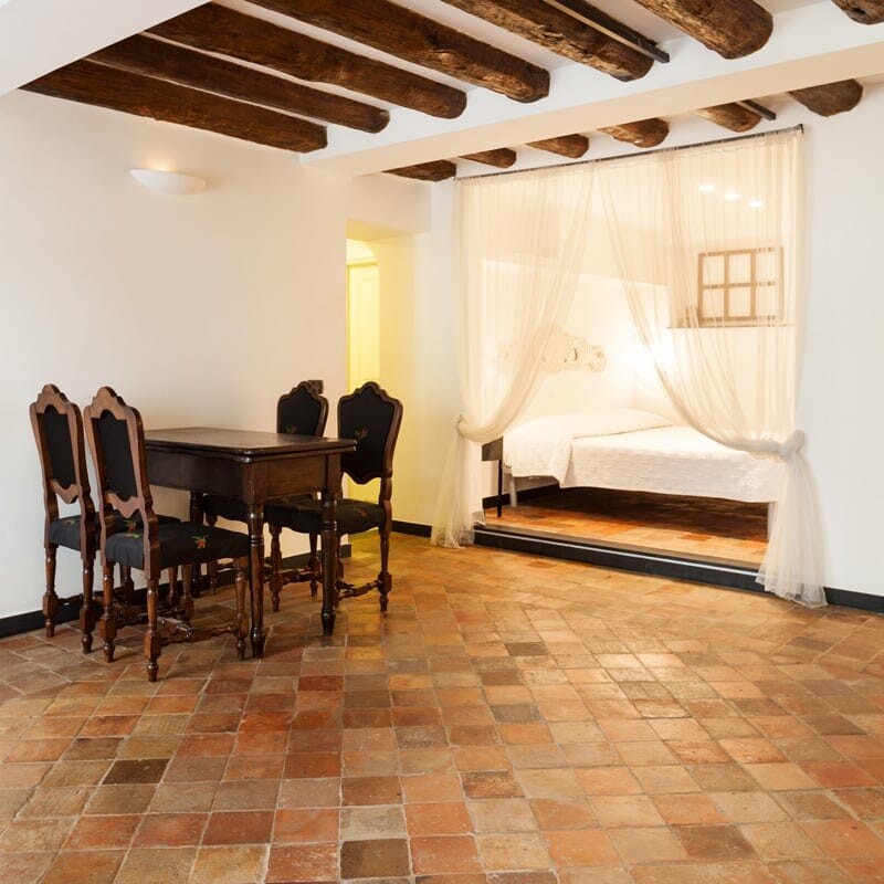 Reclaimed matte square terracotta tile floor in a traditional Spanish style interior by Country Floors