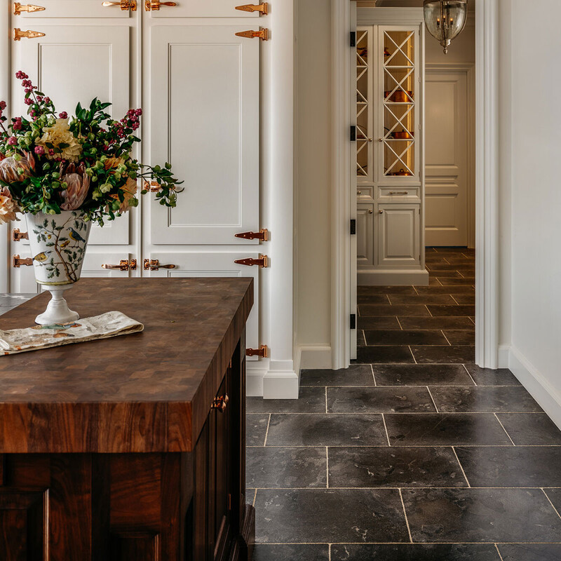 Entryway flooring with dark bluestone tiles creating sophisticated and timeless interior look by Country Floors