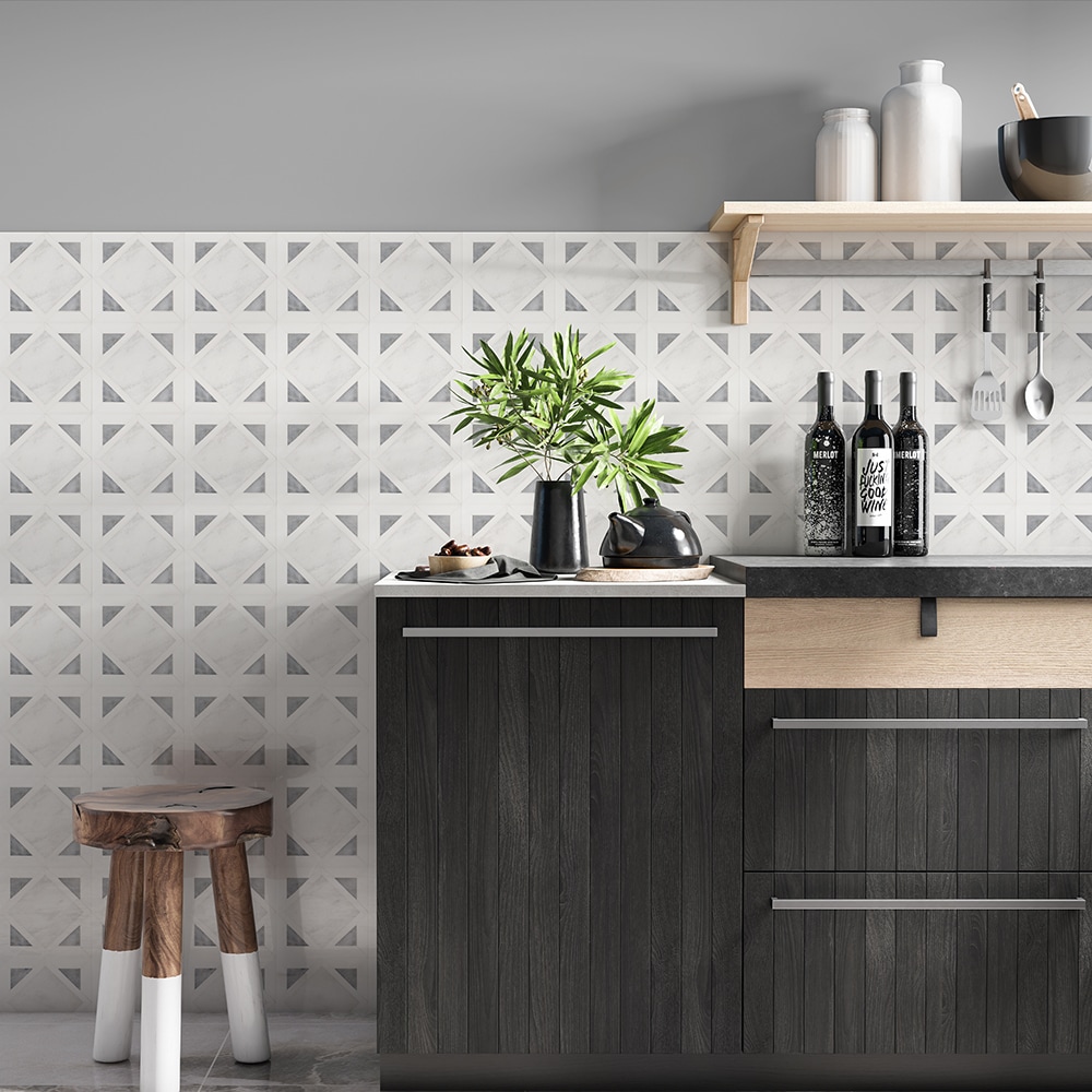 Geometric gray and white mosaic tile wall covering in a kitchen. 