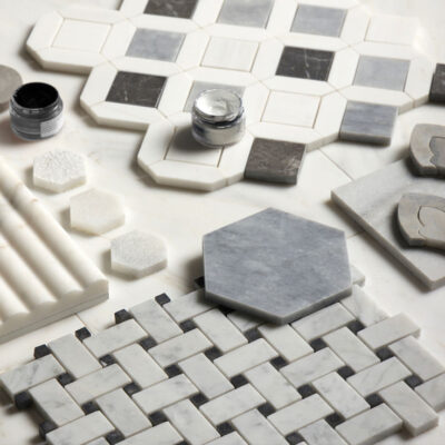 Flat lay of gray, white, and black marble mosaic tile samples