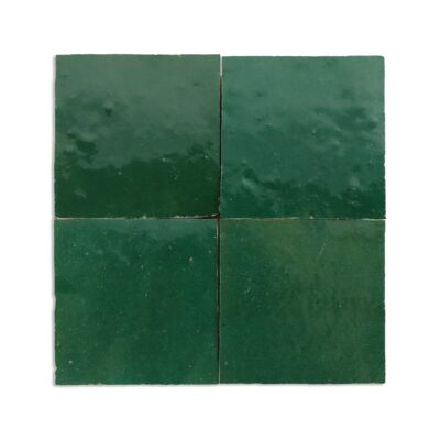 Green solid color tiles with high tonal shading and handmade surface imperfections.