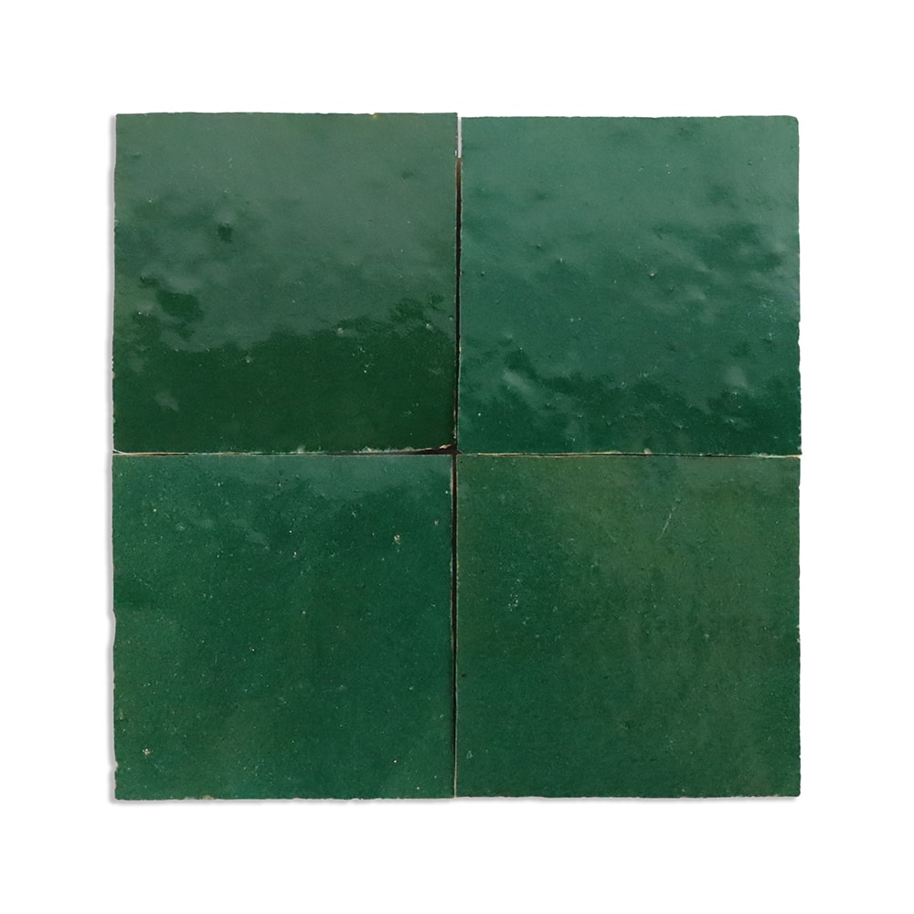 Green solid color tiles with high tonal shading and handmade surface imperfections.