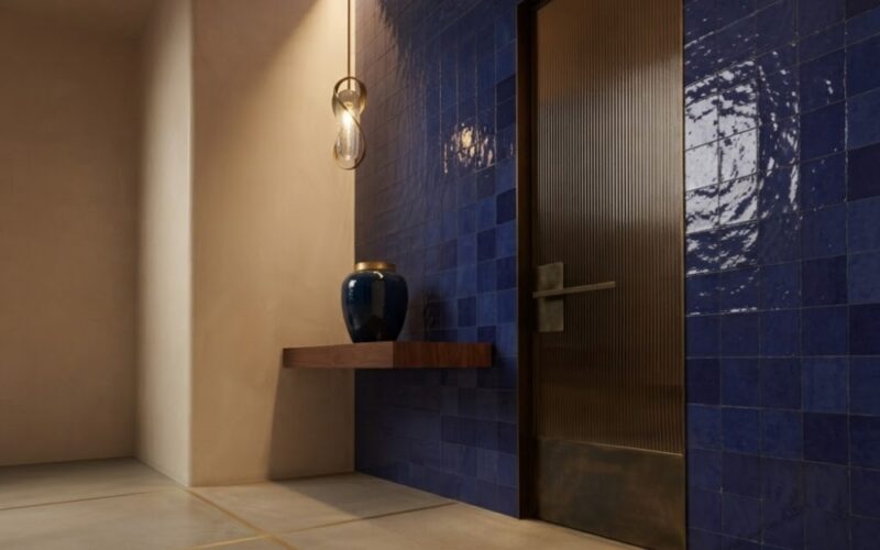 Modern hallway interior design in Anaheim featuring vibrant blue glossy Zellige wall tiles.