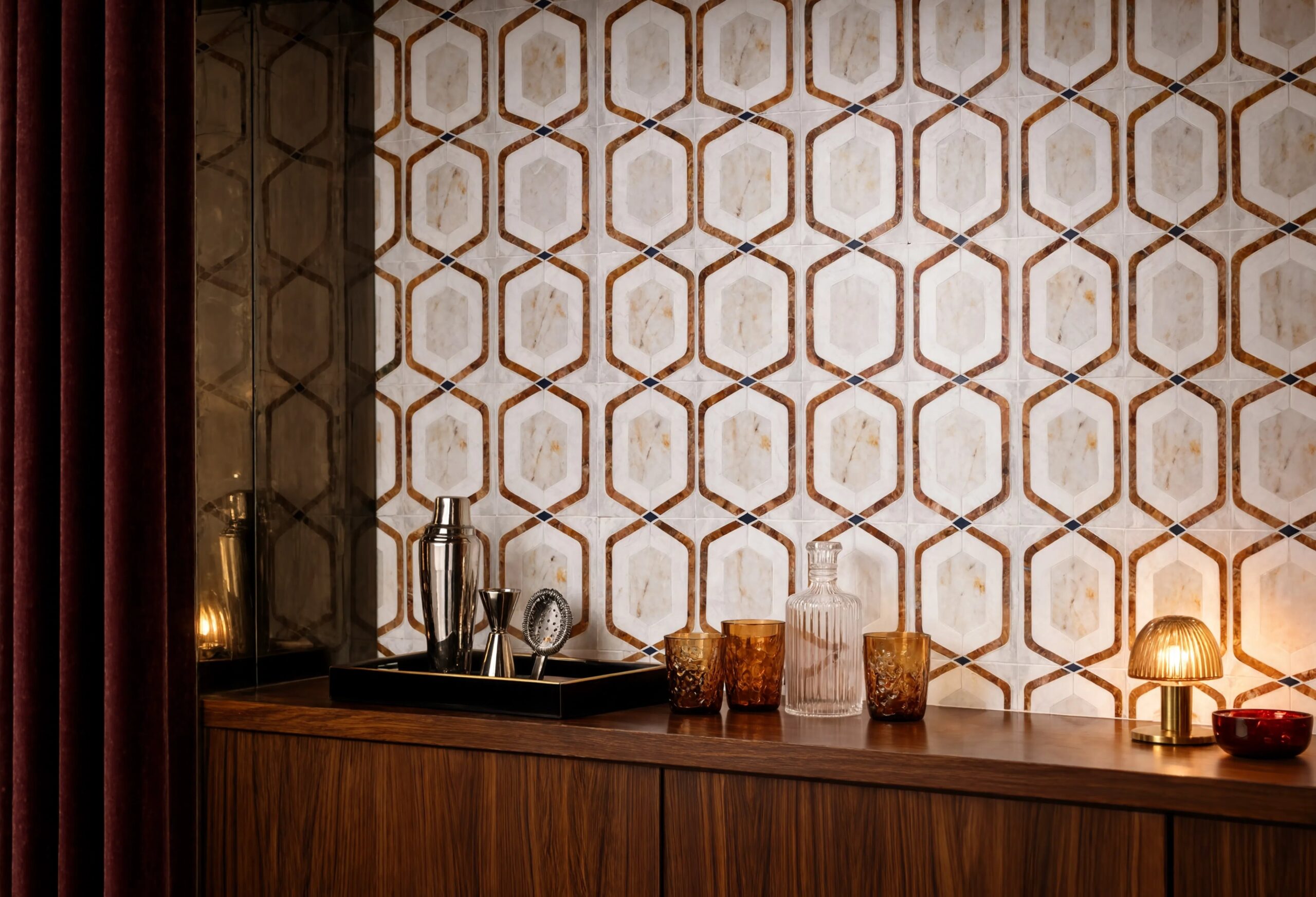 Neo deco marble mosaic backsplash tile with golden onyx hexagonal lattice pattern and navy diamond accents, installed floor to ceiling in a 70s inspired home bar styled with walnut cabinetry, amber glassware, cocktail shaker and warm directional lighting