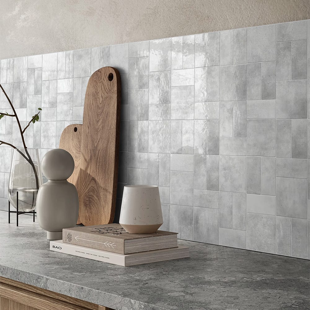 A wall featuring gray ceramic tiles